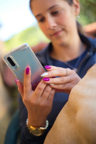 Woman Somlemly looking at phone.